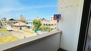 A balcony with a clear view of buildings and a street. - Zahra Apartments Bamburi (Bamburi)