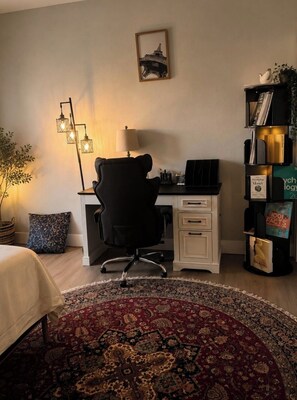 A bedroom with a bed, a desk, a chair, a bookshelf, a lamp, and a decorative wall piece. - Luxury 3BR  Walk to SAP Center & Downtown (San Jose)