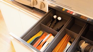 A kitchen with a stove, pots, and a drawer with utensils. - Kobayashi Building 302 (Tokyo)