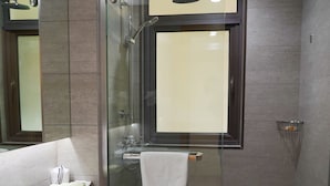 A modern bathroom with a glass-enclosed shower, a toilet, and a vanity with a mirror. - PengLai Mahota Town (Yantai)