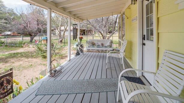 A covered porch with a bench, a welcome sign, and a view of the yard. - Payson Pines & Porch Vibes: Cool High Country Base (Payson)