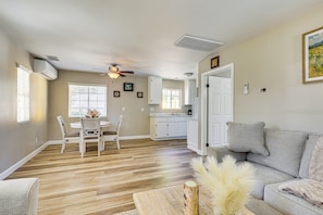A living room with a sofa, a dining area with a table and chairs, a kitchen with cabinets, and a ceiling fan. - 'La Casita Vacation Home' in Temecula Valley! (Temecula)