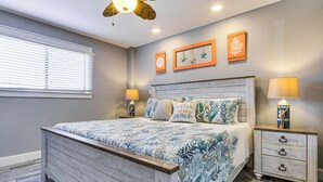 A bedroom with a bed, bedside tables, and wall decorations. - Walk to Beach! Family-Friendly Hilton Head Condo (Hilton Head Island)
