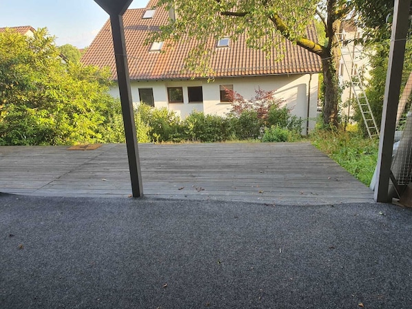 A paved driveway leading to a house with a tiled roof, surrounded by greenery and a ladder leaning against a tree. - Vacation apartment in Bietigheim-Bissingen (Bietigheim-Bissingen)
