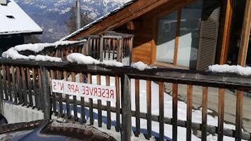 A wooden cabin with a sign that reads 'RECEIVE YOUR PARTS HERE.'
