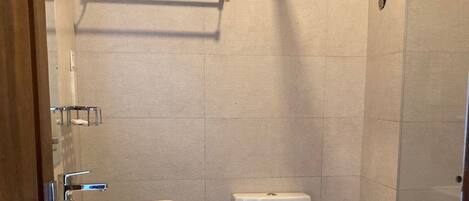 A bathroom with a pedestal sink, toilet, and a towel rack.