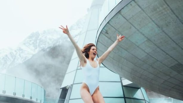 A person jumping into a pool with a modern architectural structure in the background. - Gasthof Stern (Oetz)