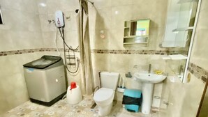 A bathroom with a toilet, sink, shower, and a trash bin. - Lens Staycation Serene 2-BDR-1BR-KTCHN-Wifihouse with AC in peaceful Panabo (Panabo)