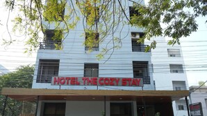 A building with a sign reading 'HOTEL THE COZY STAY'. - Hotel The Cozy Stay (Indore)