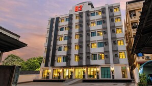 A multi-story hotel with a prominent 'B2' sign, large windows, and a well-lit entrance. - B2 Future Park Rangsit Boutique & Budget (Thanyaburi)