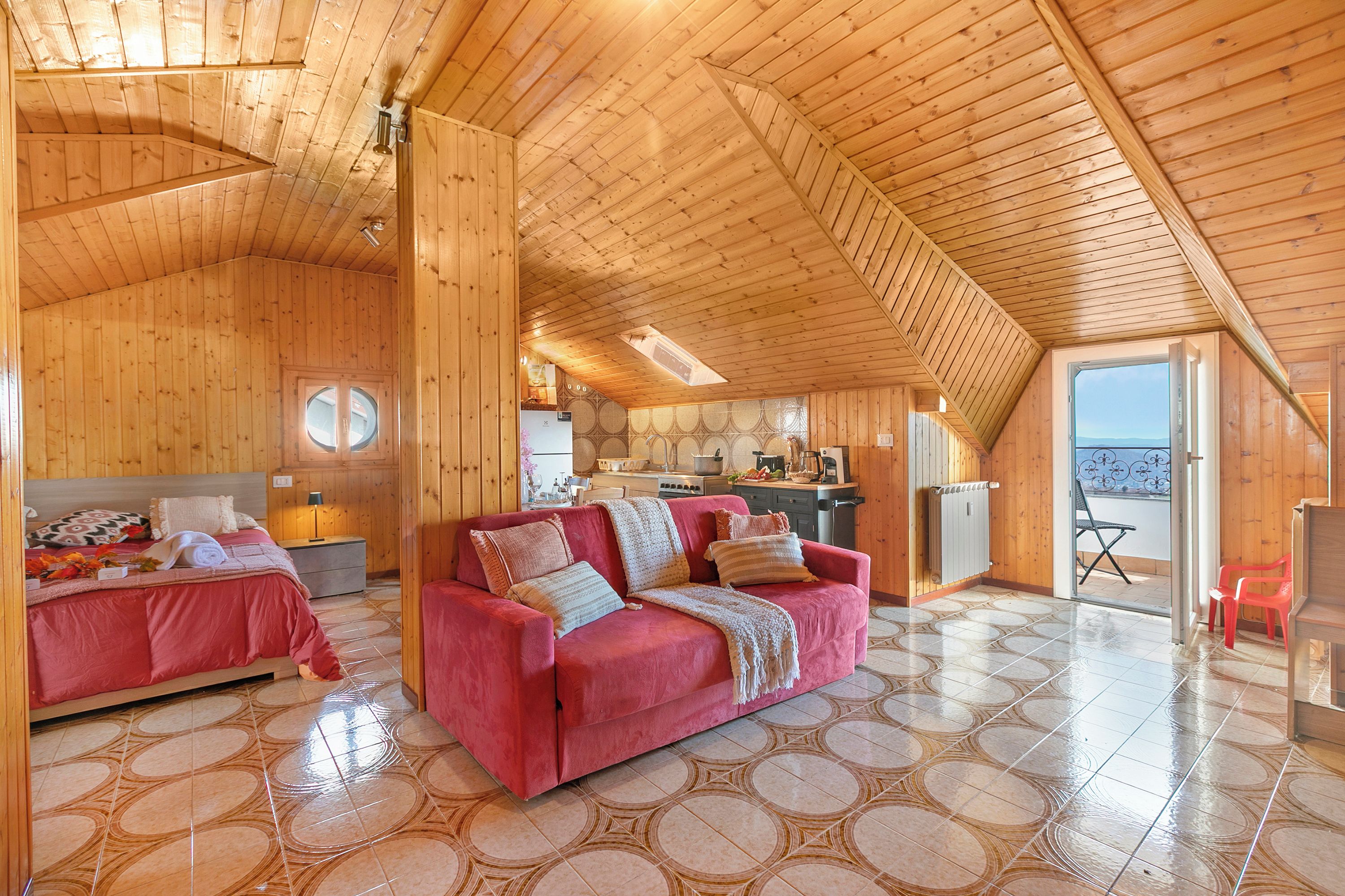 L’intérieur d’une cabane en bois comprend un coin repas, une cuisine et deux chambres à coucher avec des lits.