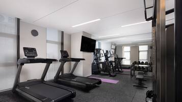 A gym with treadmills, ellipticals, and weight machines.