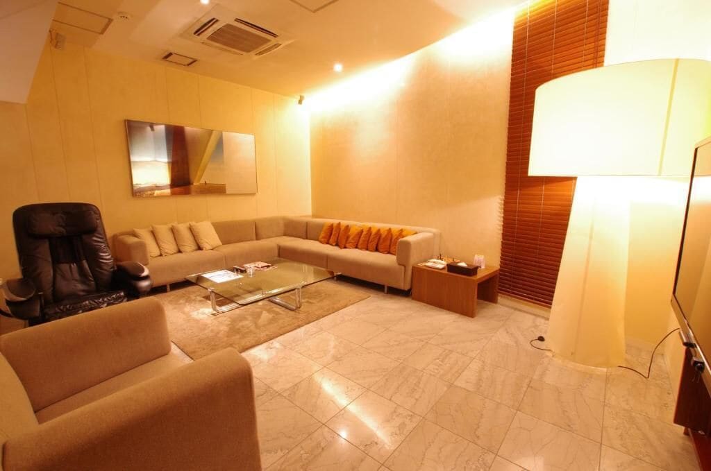 A modern living room with a sofa, armchair, and a coffee table.