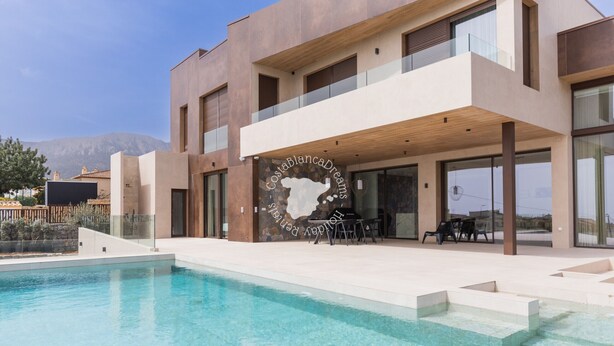A modern two-story building with a swimming pool, outdoor seating, and a view of mountains. - CostaBlancaDreams - AIR in Calpe (Calpe)