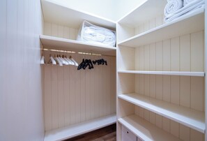 A walk-in closet with hanging space and shelves. - The Haven Suite in Duomo (Milano)