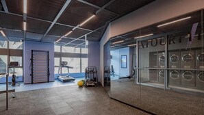 A gym with exercise equipment, a treadmill, and a large window. - Atour S Hotel  Hongqiao Center Shanghai (Shanghai)