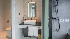 A modern bathroom with a marble vanity, a mirror, a handheld showerhead, and a toilet. - Atour S Hotel  Hongqiao Center Shanghai (Shanghai)