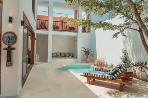 A pool area with lounge chairs, a staircase, and a balcony with plants. - Furaha House - Diani, Eden Escapes (Diani Beach)
