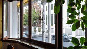 A window with a view of a street, a building with columns, and a car parked outside. - The Cape Town Club (Cape Town)