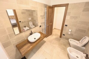Een douche, een haardroger, een bidet, handdoeken