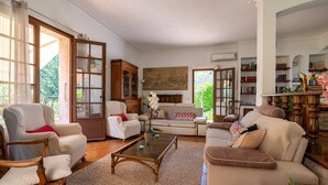 A spacious living room with a fireplace, a large window, and a bookshelf. - Provencial Villa in Vence with Private Swimming Pool (Vence)