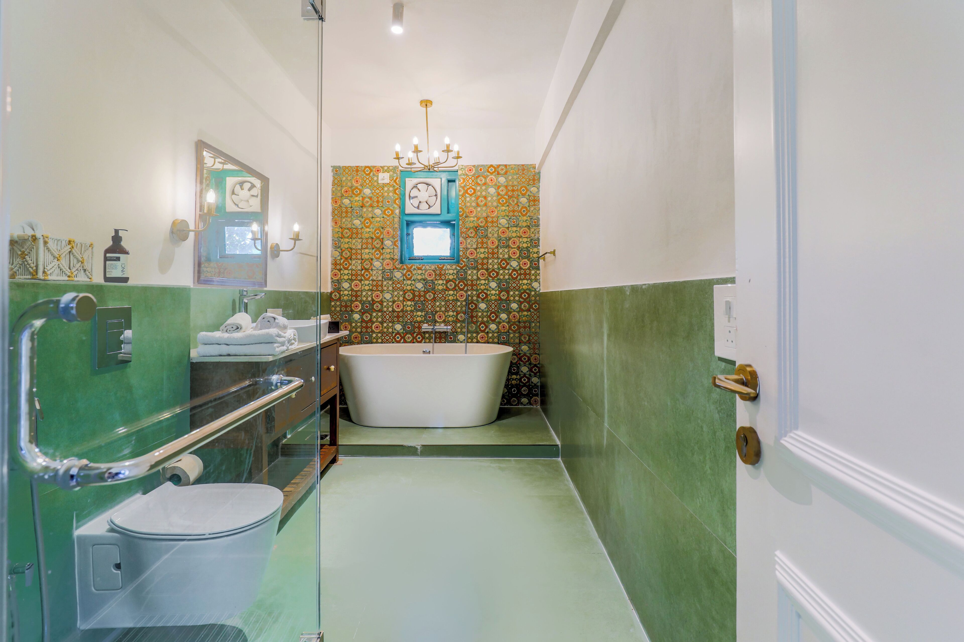 A bathroom with a bathtub, toilet, and shower area.