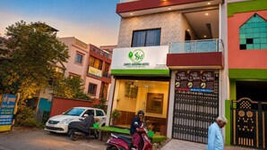 A hotel with a signboard, a gated entrance, and a parked scooter. - Shree Krishna Hotel  (Ujjain)