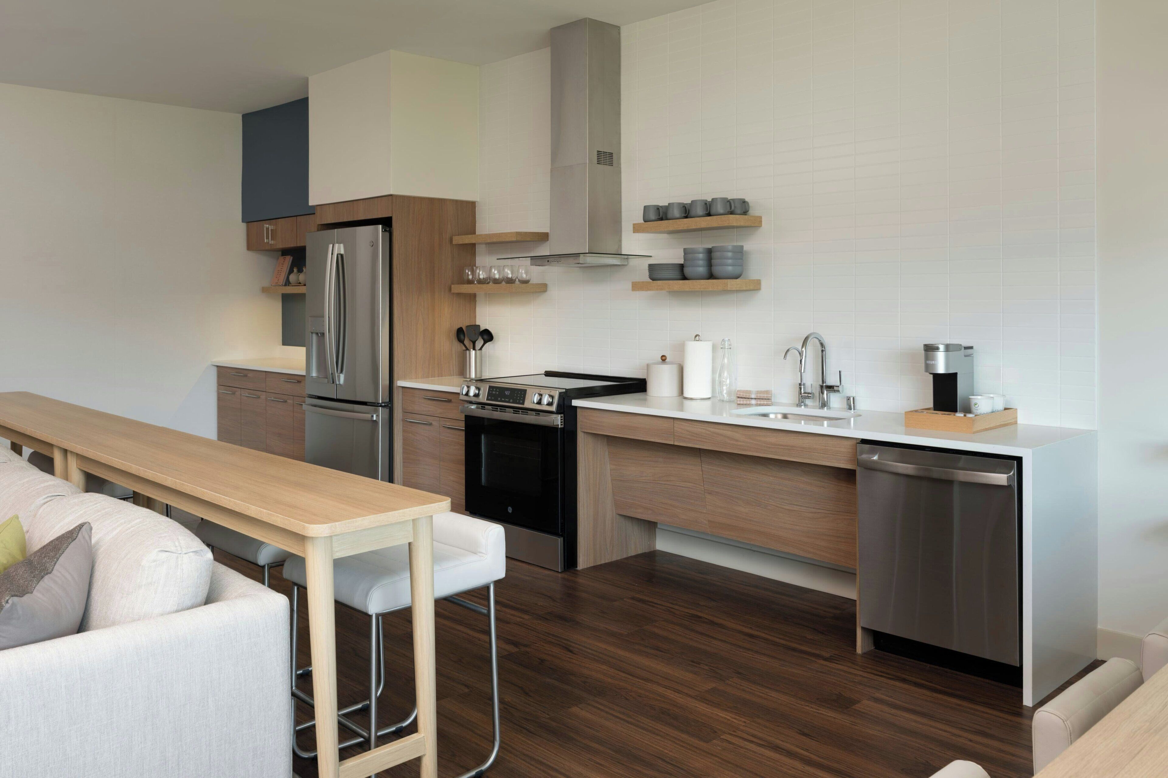 A modern kitchen with a built-in oven, refrigerator, and dishwasher.