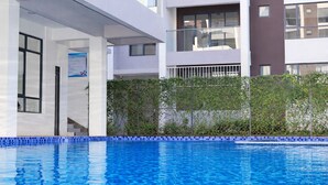 A modern hotel with a swimming pool, balconies, and a white facade. - Welcome to your modern, peaceful escape just minutes from the airport &CBD (Nairobi)