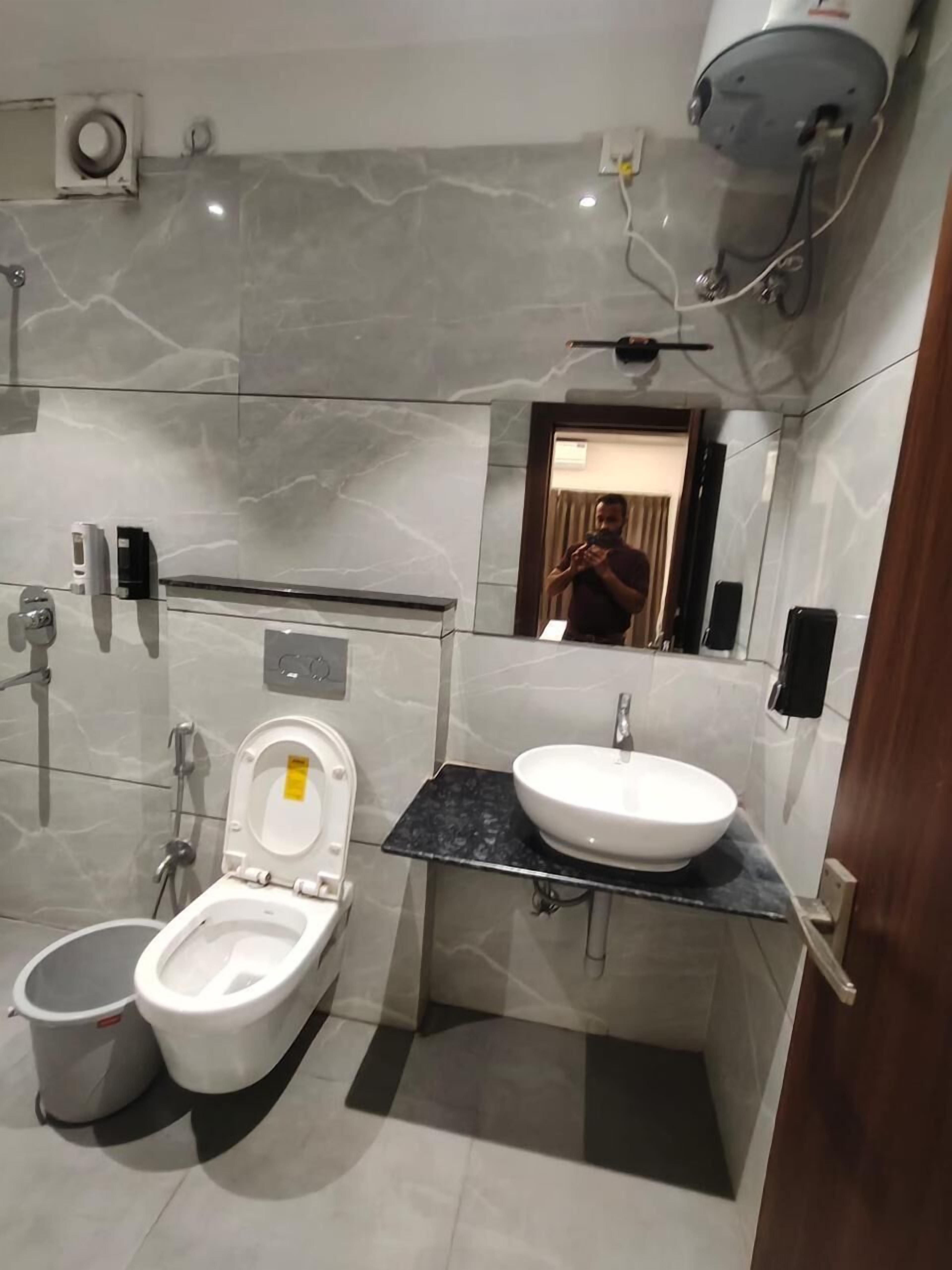 A modern bathroom with a toilet, bidet, and sink.
