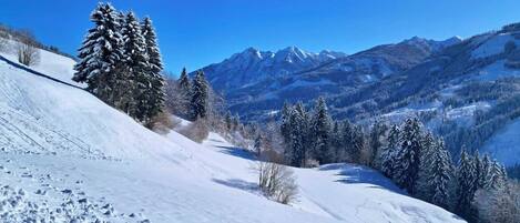 A snowy mountain landscape with a clear sky.