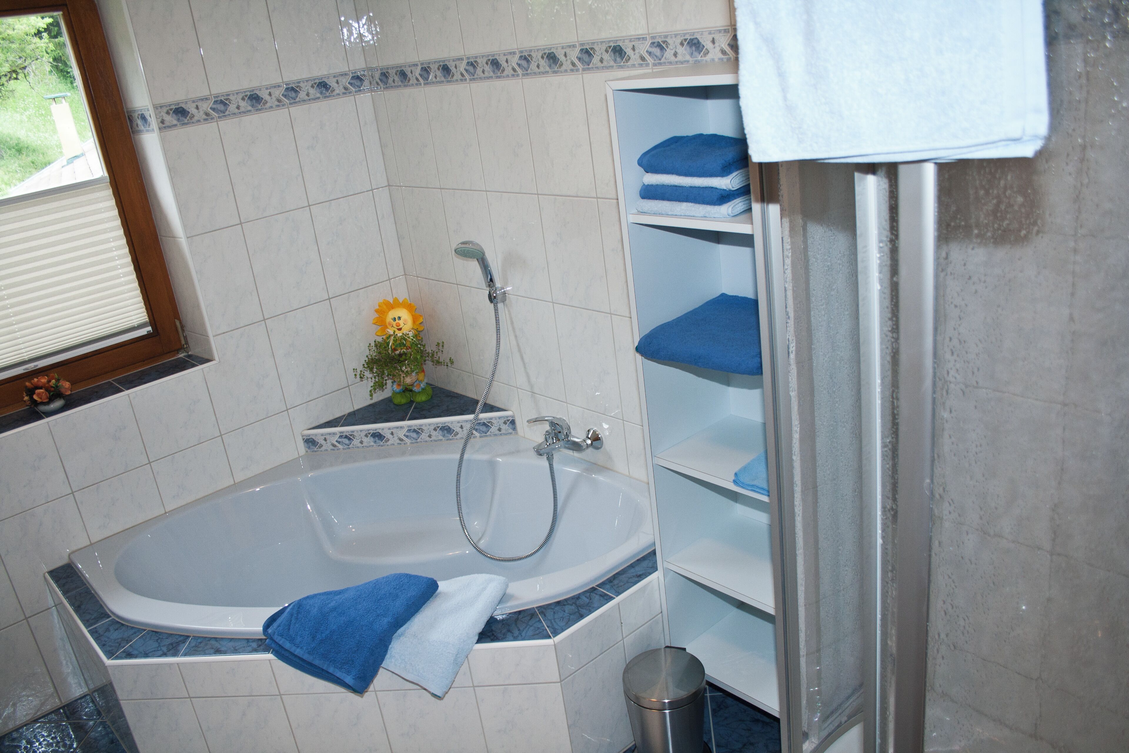 A bathroom with a bathtub, a shower, and a sink.