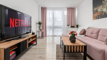 Comfort Apartment | Living area | 40-inch flat-screen TV with cable channels