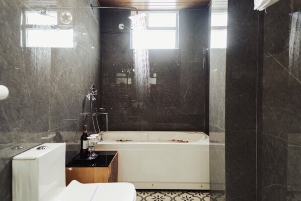 A modern bathroom with a bathtub, a shower, and a toilet. - Avira Hotel (Gangtok)