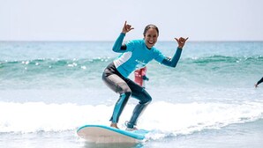 A person surfing on a wave. - Luxury Camping Pod for Two to Go Glamping near Auckland (Te Arai)