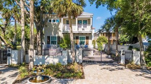 A gated residential area with a two-story building, a fountain, and a paved walkway. - Villa Mojito A&B | Historic Downtown (St. Augustine)