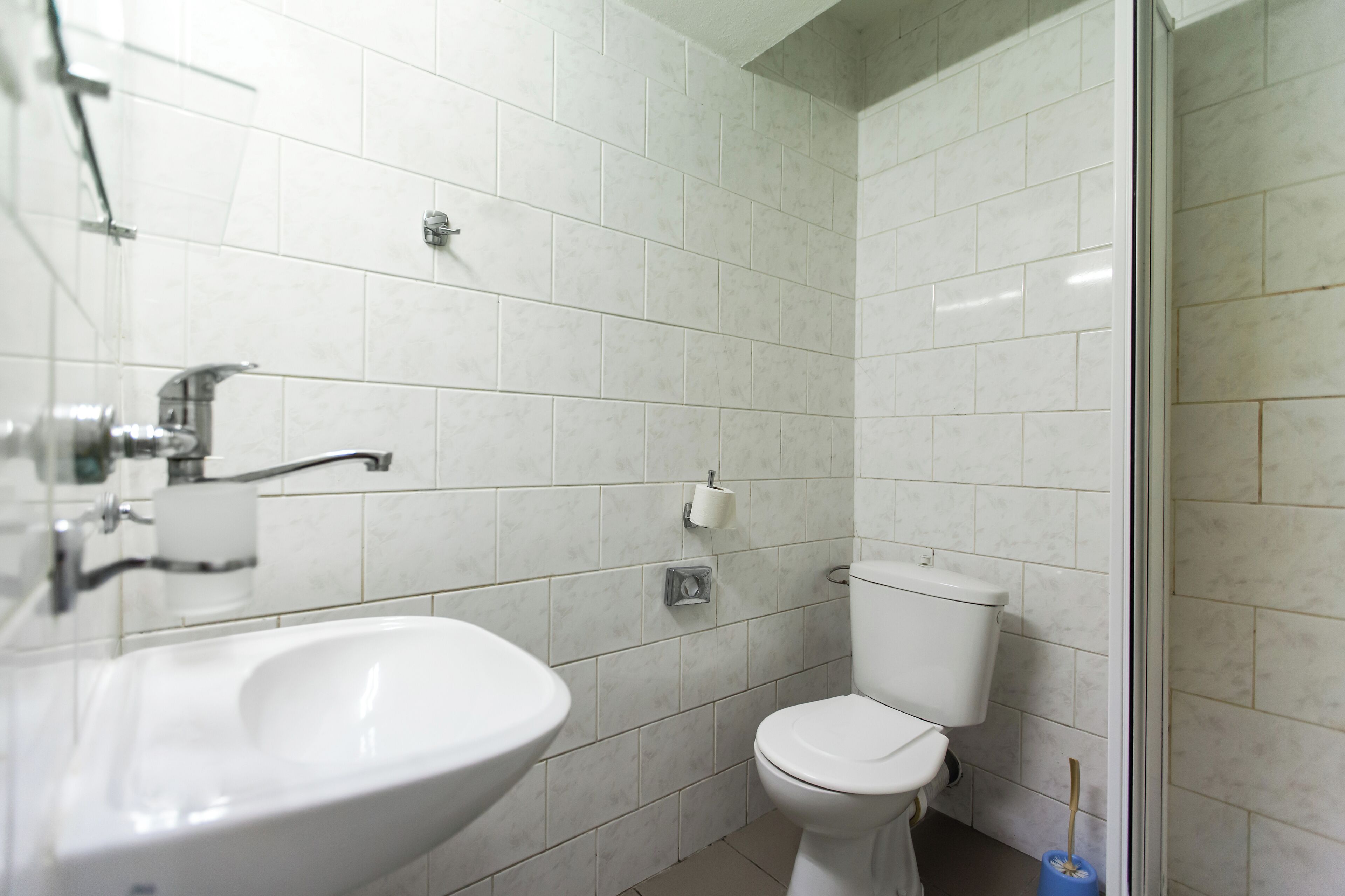 A bathroom with a sink, toilet, and shower.