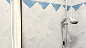A shower with a chrome faucet and hose, set against a wall with a diamond-patterned tile design. - SE182 - Senigallia, three-room apartment facing the sea with balcony and parking space (Senigallia)
