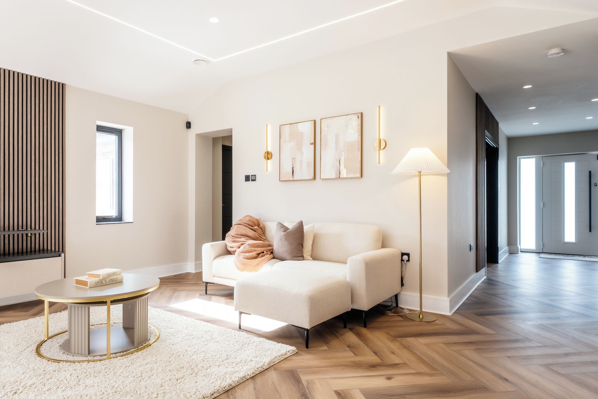 A modern living room with a sofa, a round coffee table, and a floor lamp.