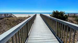 A wooden boardwalk leading to a beach with clear skies. - 20% off 3-7 thru Dec. Oceanfront 2BR 2BA. Crescent Shores. Views!! Amenities!! (North Myrtle Beach)