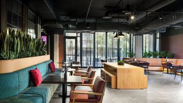 A modern interior with seating, tables, and large windows.