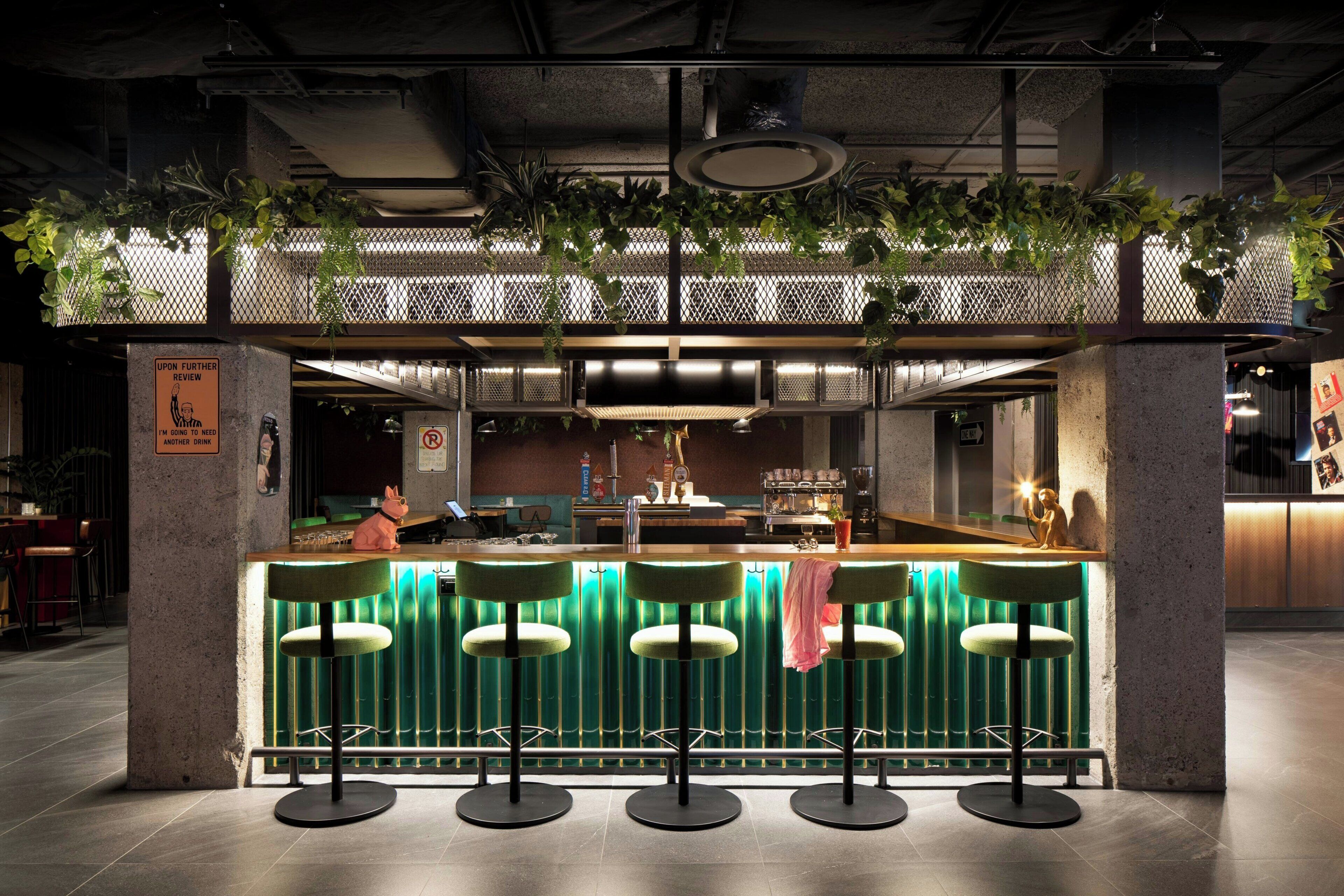A bar area with a counter, stools, and a sign indicating a one-way direction.