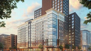 A multi-story hotel with a modern facade, large windows, and a Starbucks on the ground floor.
