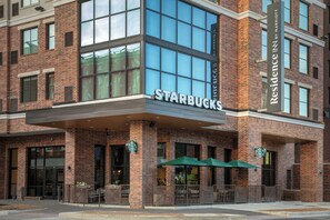 A Starbucks with a brick facade and large windows. - Residence Inn by Marriott San Antonio Riverwalk (San Antonio)
