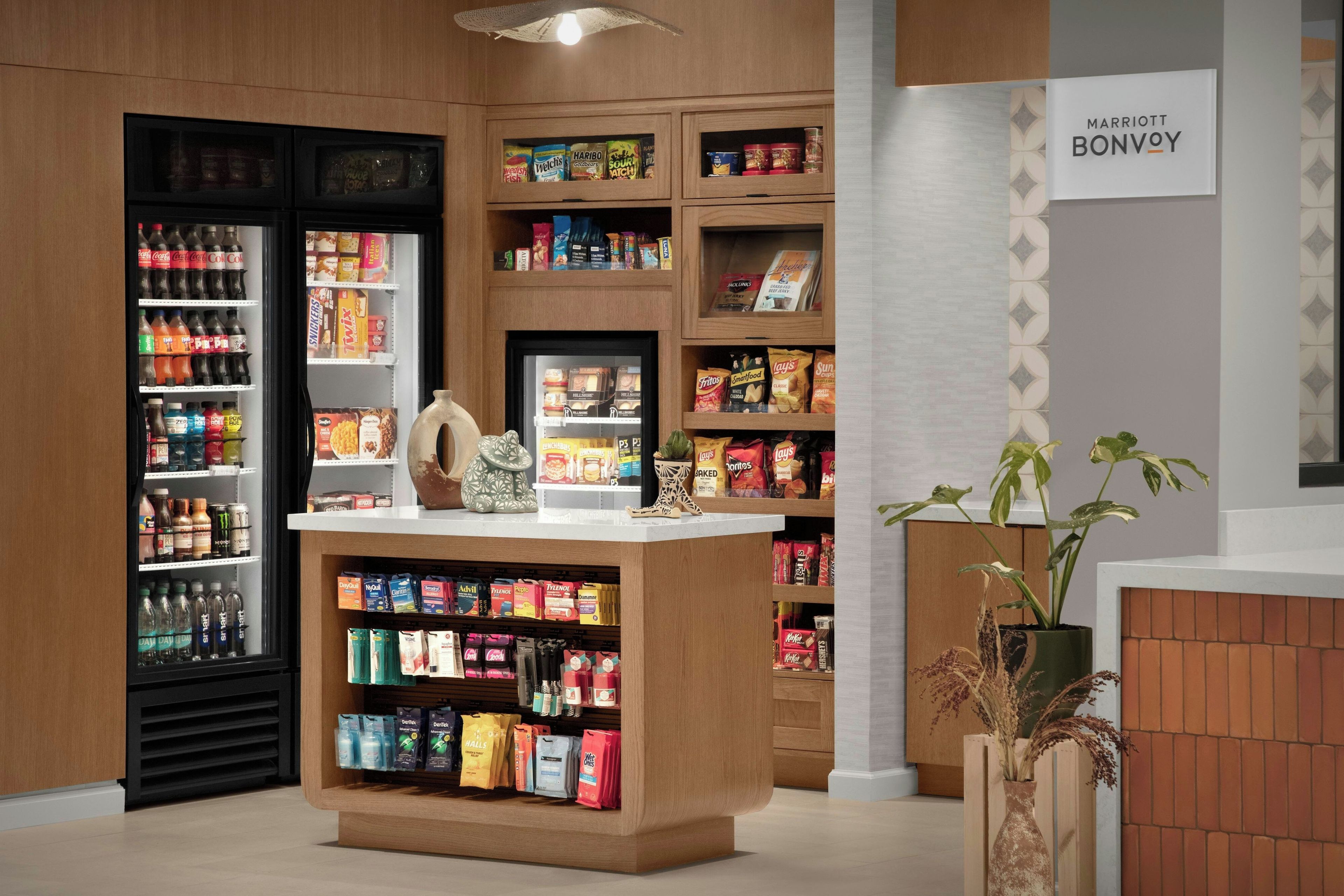 A snack and beverage kiosk with a variety of products including snacks, drinks, and condiments.