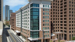 A multi-story hotel with a modern design, featuring a prominent Starbucks on the ground floor. - Residence Inn by Marriott San Antonio Riverwalk (San Antonio)