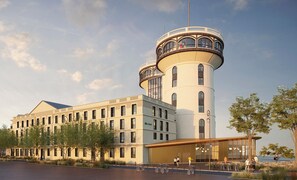 A modern building with a tower, large windows, and a covered entrance. - Ibis Styles Saint Germain En Laye (Saint-Germain-en-Laye)