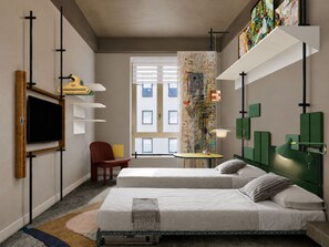A modern hotel room with two beds, a TV, a desk, and artwork on the walls.