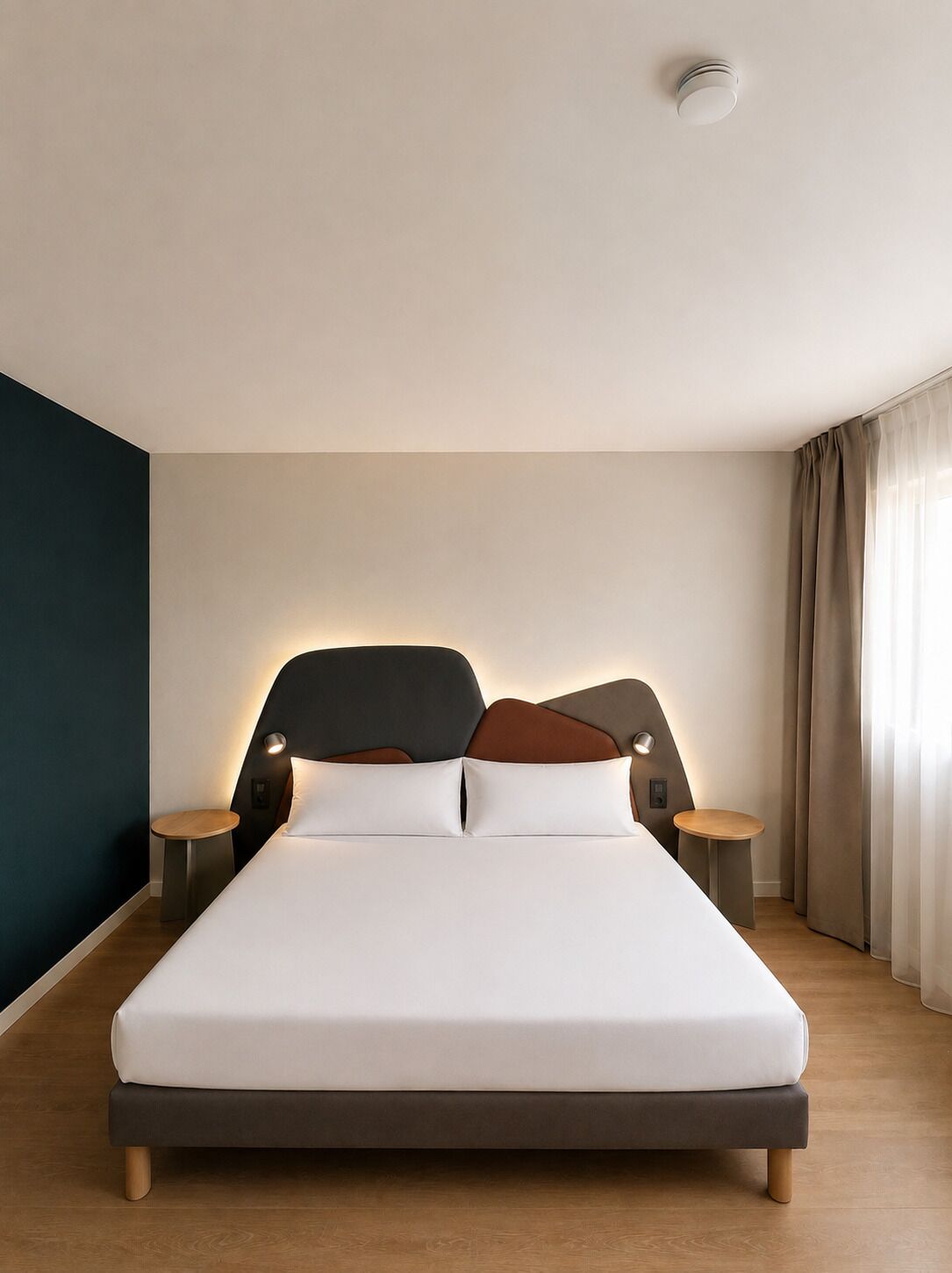 Una habitación de hotel moderna con una cama grande, dos mesitas de noche y una lámpara de techo.