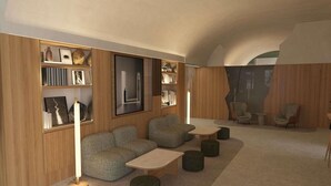 A modern interior with a sofa, ottomans, a coffee table, and a bookshelf. - ibis Styles Zumaia Zestoa (Zestoa)